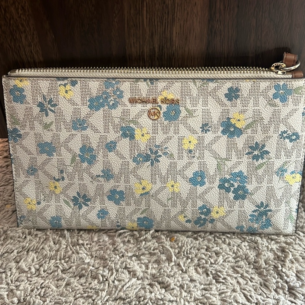 A Michael Kors  blue and yellow flowers floral design wristlet.